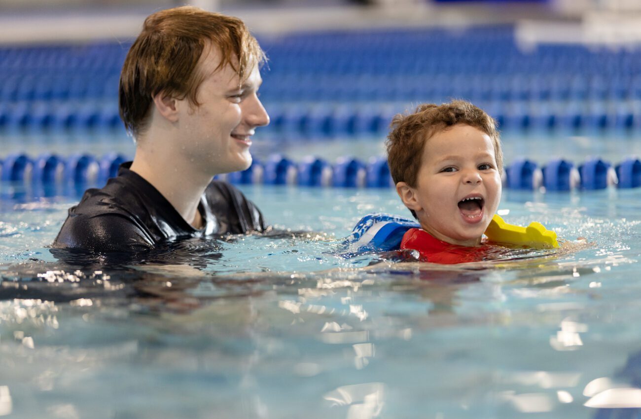 Swim instructor with a child in the pool for a swim lesson